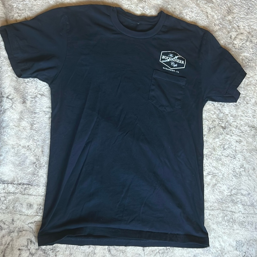 The Buccaneer Cafe, Oceanside, CA. Navy blue, short sleeved tee shirt.